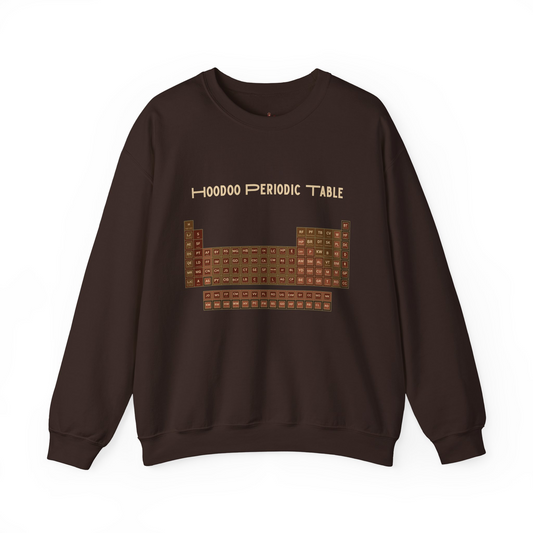 A dark brown crewneck sweatshirt featuring a graphic of a 'Hoodoo Periodic Table' printed on the chest in a stylized, slightly distorted periodic table layout with beige text.